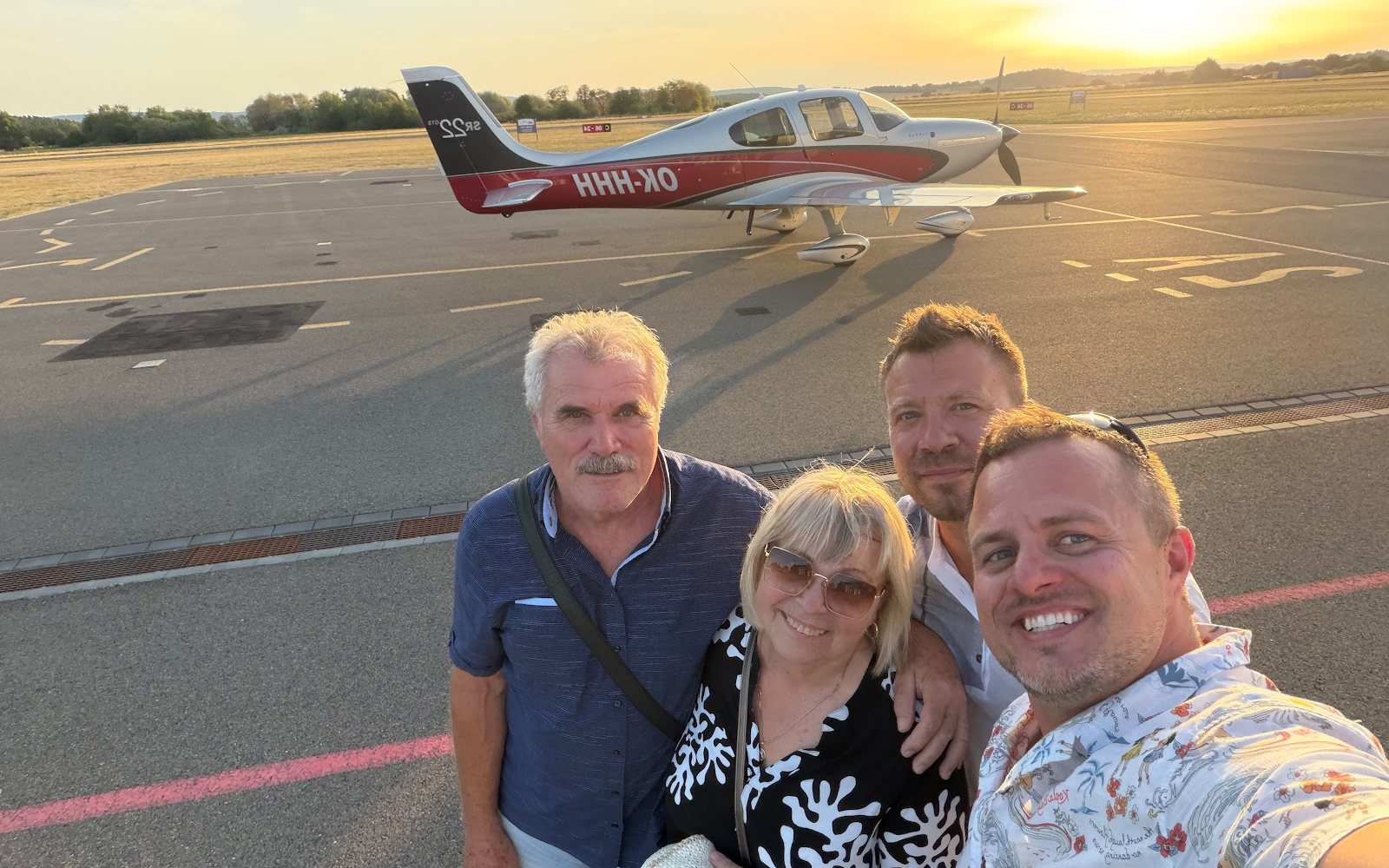 Passengers by the aircraft at sunset